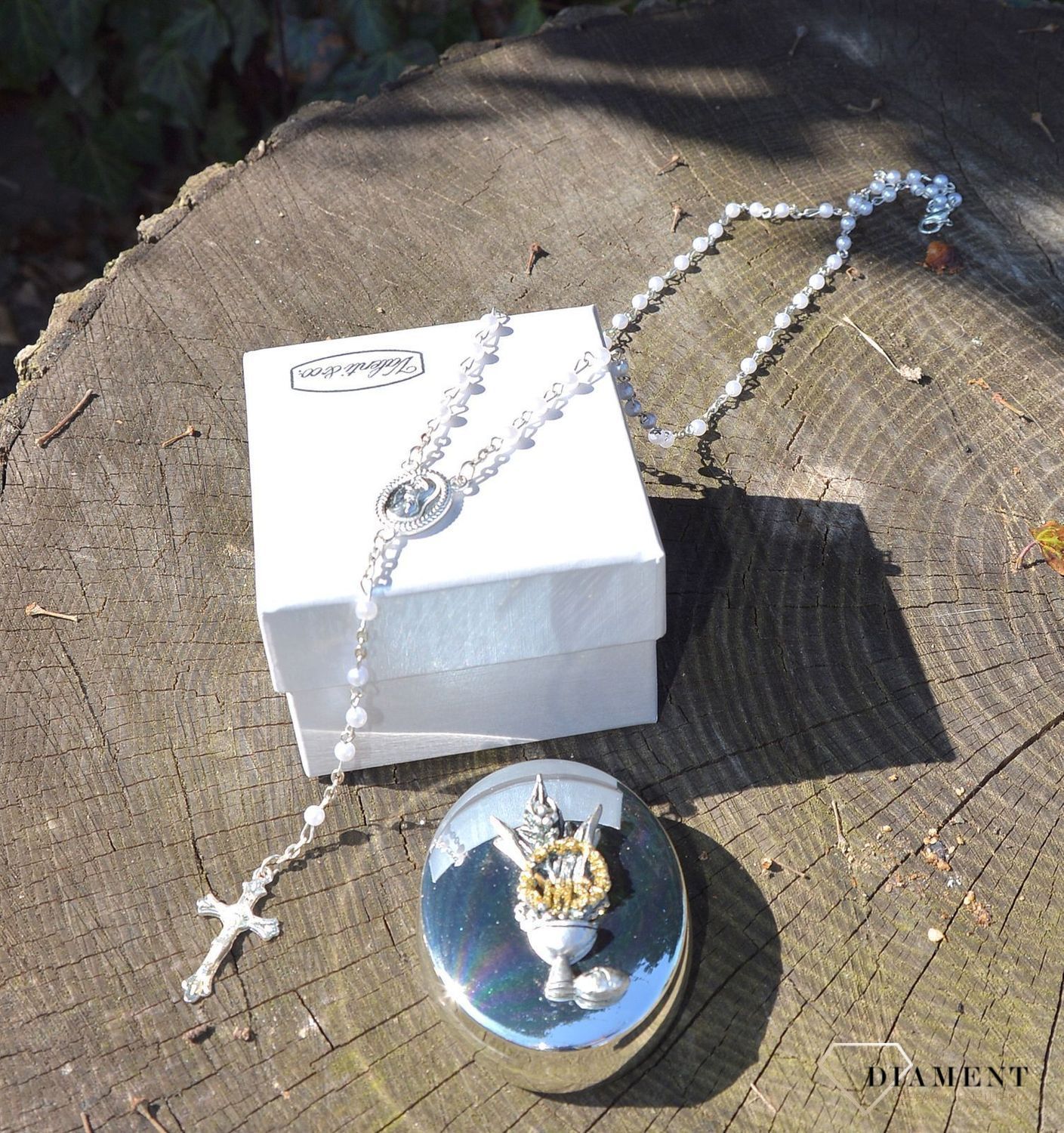 Różaniec komunijny z koralików w kolorze perłowym w pięknym, ozdobnym posrebrzanym opakowaniu. Komunia Św. to 4 symbole różaniec, książeczka, medalik oraz świeca (1).JPG